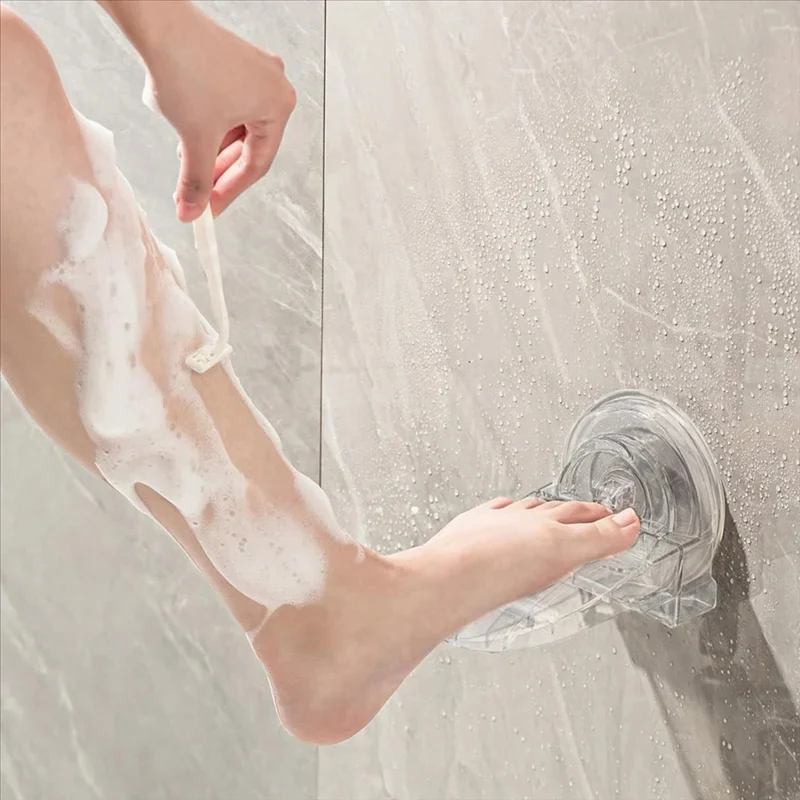No-slip shower foot rest attached to a tiled wall
